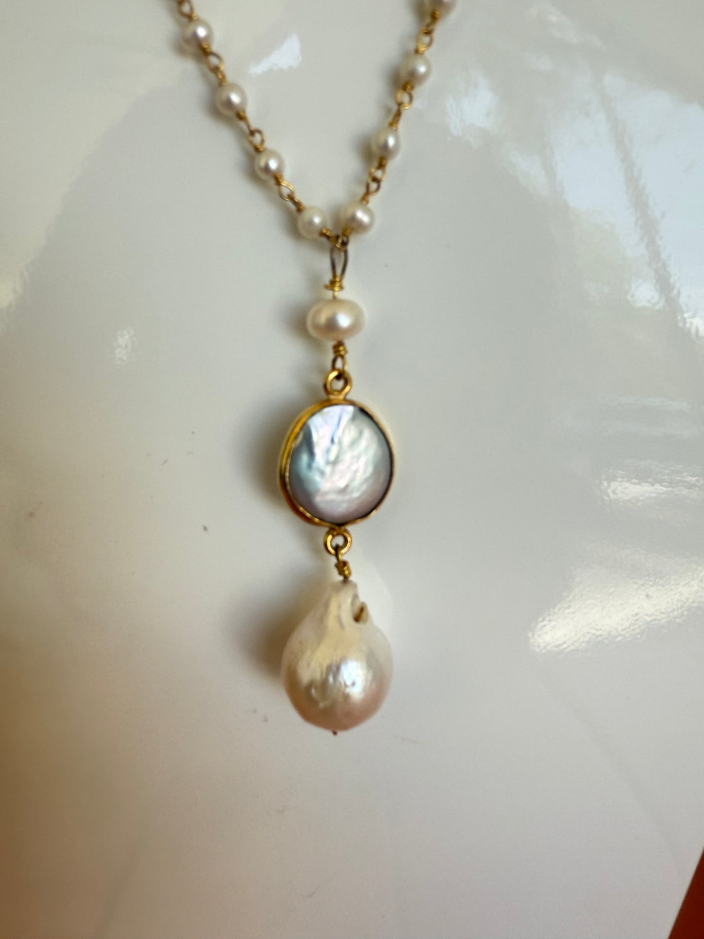 Pearl necklace with gold chain on a white surface,17" Baby Pearl Necklace with a 2" Waterfresh pearl drop charm