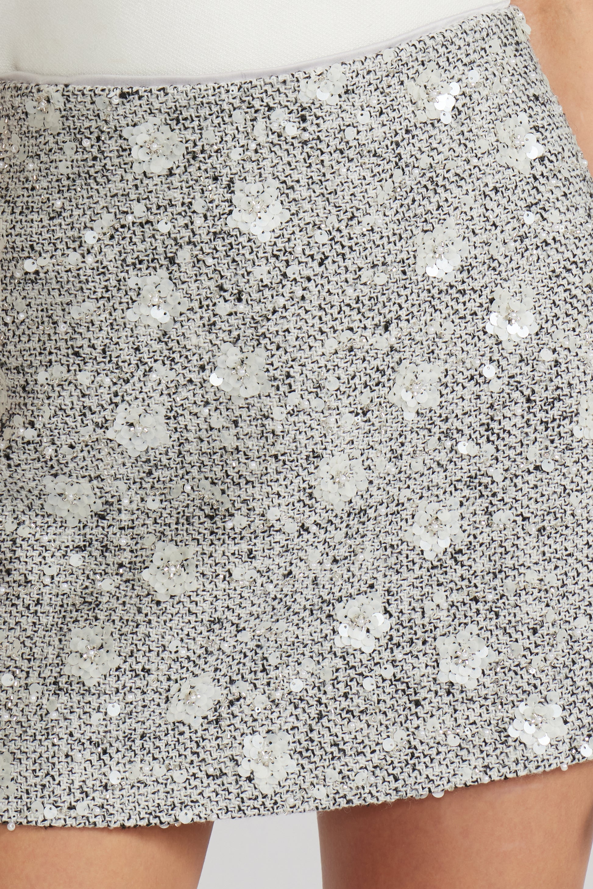 Close-up of a sequined skirt with a white background, a staple for curated boutique fashion and chic affordable style available at your Womens Boutique West Palm Beach, FL.