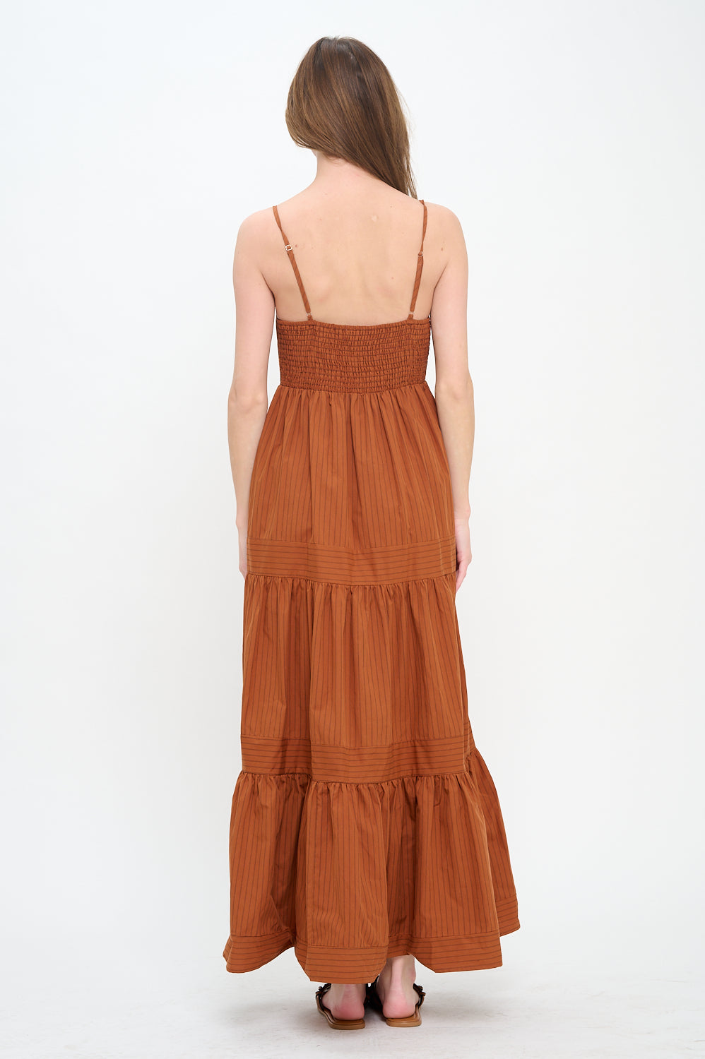 Brown tiered dress worn by a person on a white background,a staple for curated boutique fashion and chic affordable style available at your Womens Boutique West Palm Beach, FL.