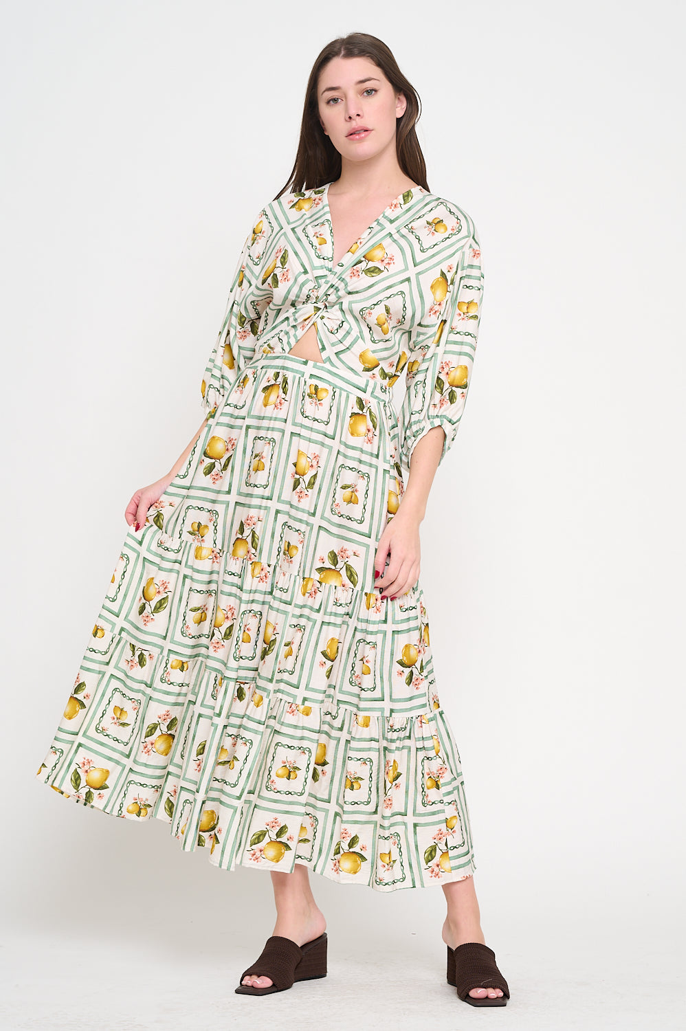 Woman wearing a patterned dress on a white background, Alana 3/4 Sleeve Maxi Dress a staple for curated boutique fashion and chic affordable style available at your Womens Boutique West Palm Beach, FL.