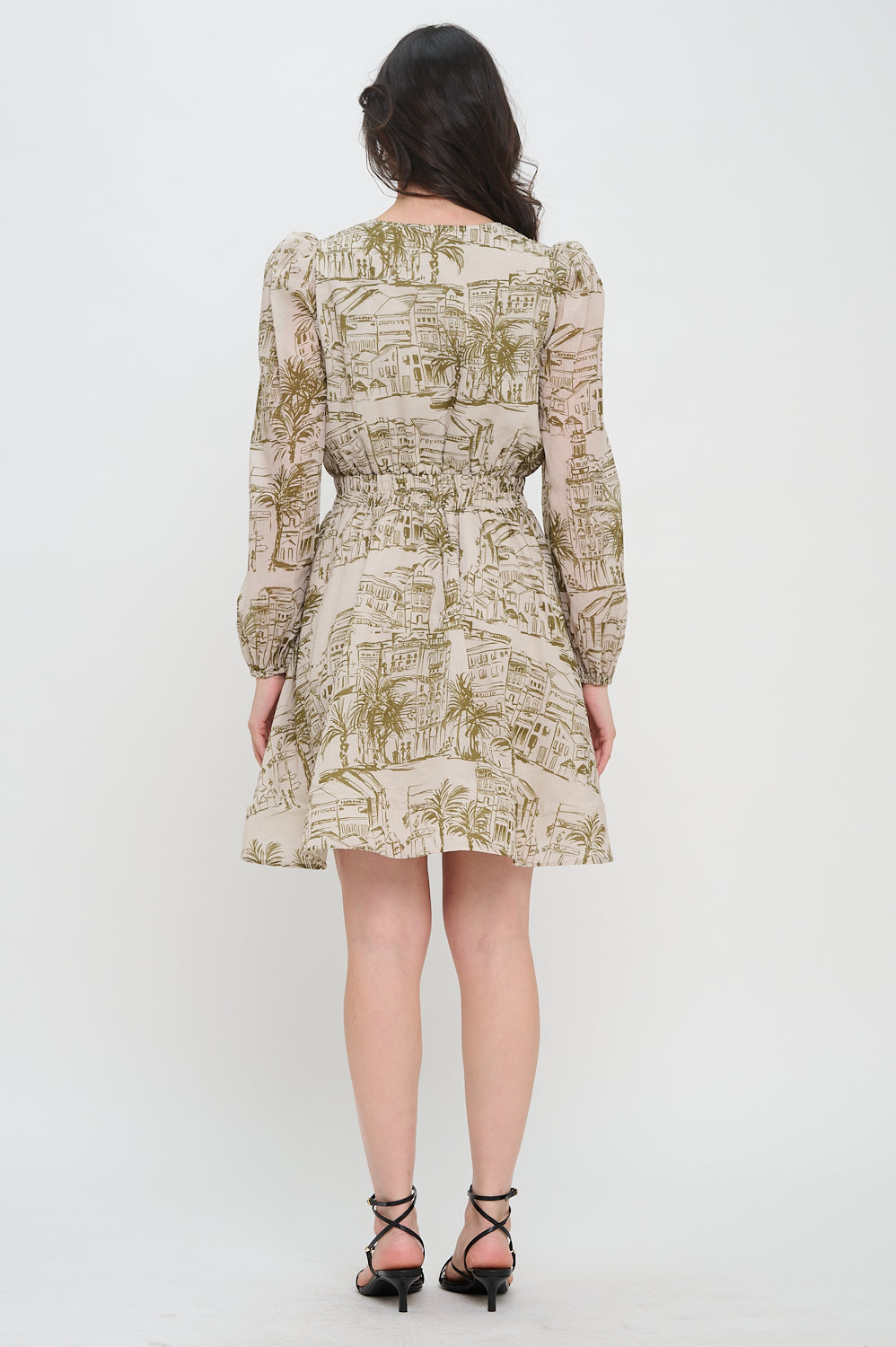 Woman wearing a patterned dress on a white background, Woman wearing a patterned dress on a white background,  Alexis Santorini Sketch L/S Short Dress, a staple for curated boutique fashion and chic affordable style available at your Womens Boutique West Palm Beach, FL.