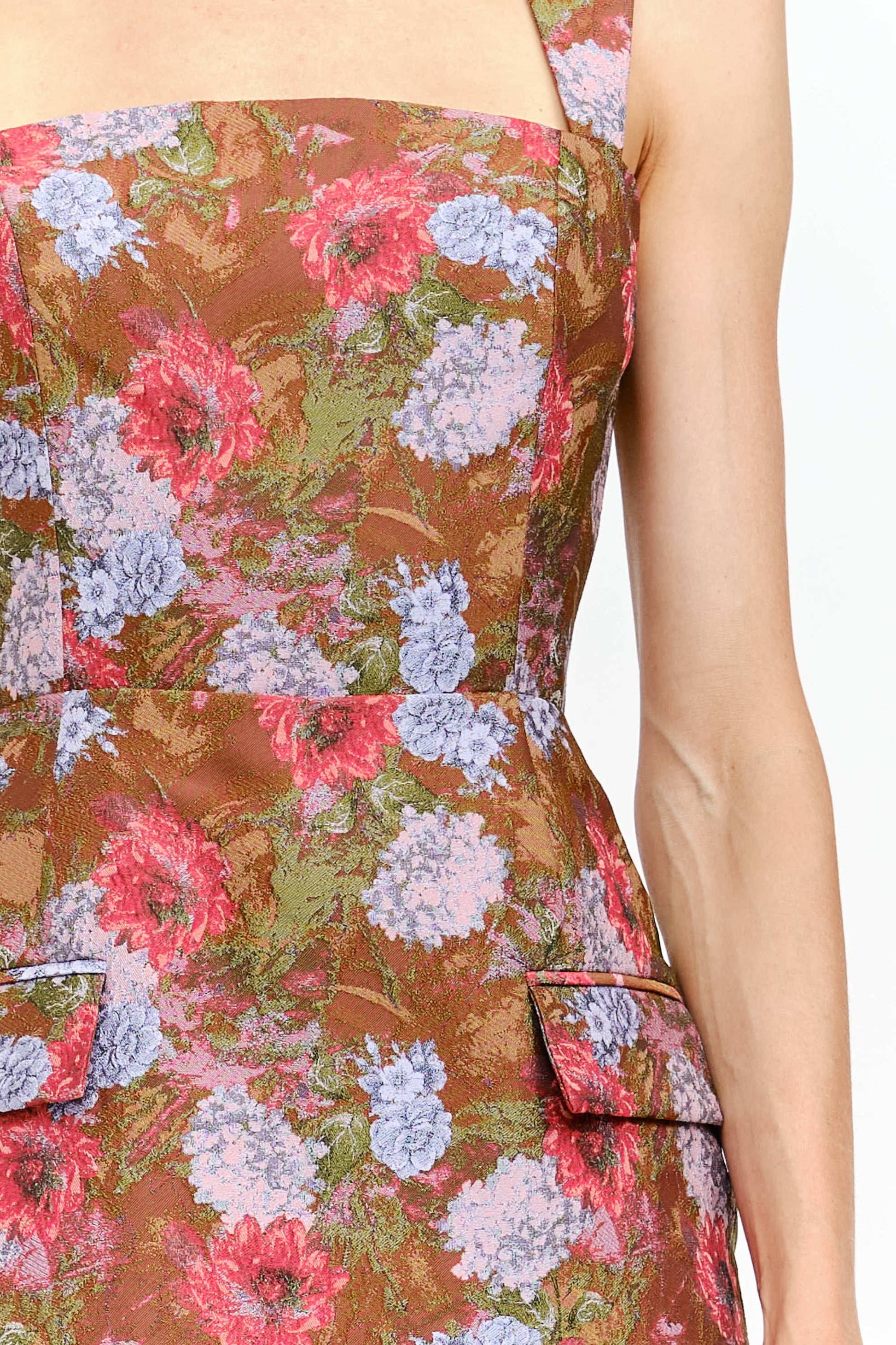 Floral dress with a mix of pink, blue, and green flowers on a brown background