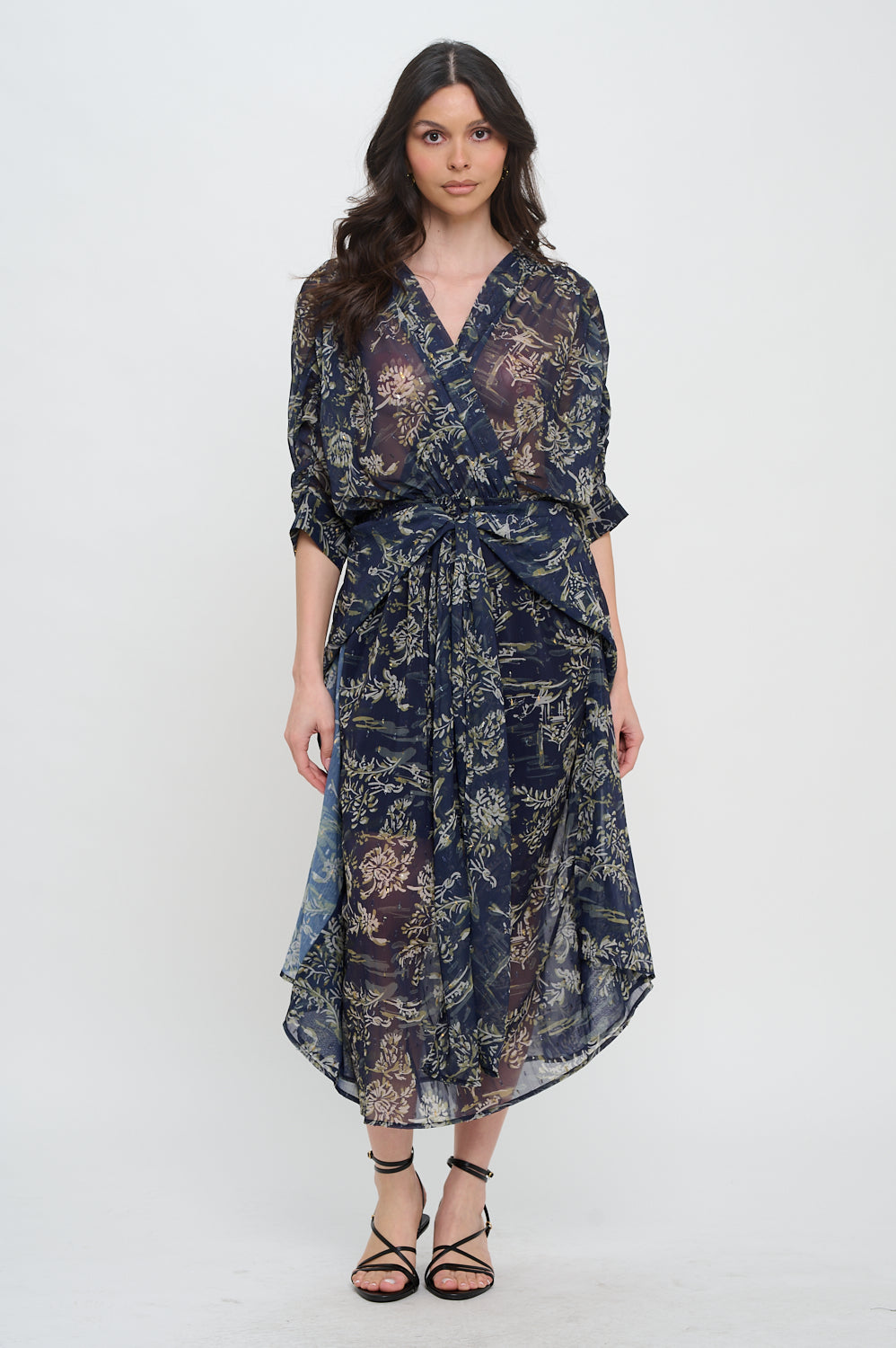Woman wearing a dark floral dress on a white background, Capri Printed Maxi Dress, a staple for curated boutique fashion and chic affordable style available at your Womens Boutique West Palm Beach, FL.