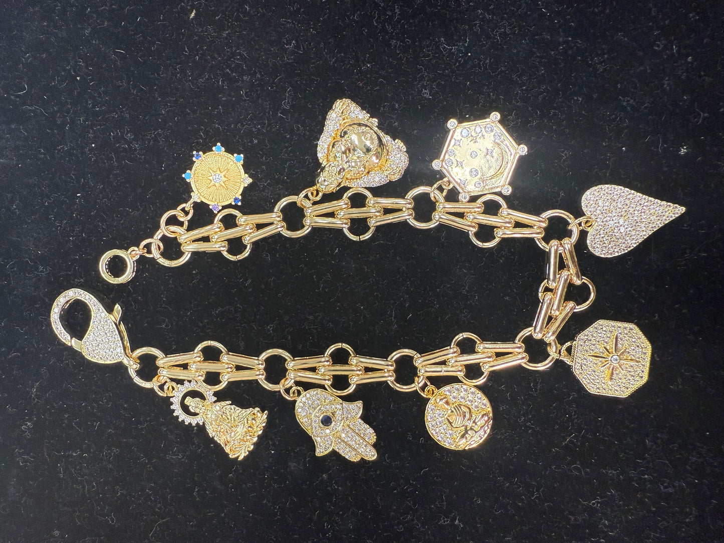 Add a touch of sparkle and fun to your wrist with this charm bracelet featuring a large lobster claw clasp adorned with dazzling cubic zirconia stones. Its playful design makes it perfect for mixing and matching with your favorite charms, adding personality and shine to any outfit. Durable and eye-catching, this bracelet is sure to become your new go-to accessory for everyday adventures. A staple for curated boutique fashion and chic 
style available at your Women's Boutique West Palm Beach, FL
CS101