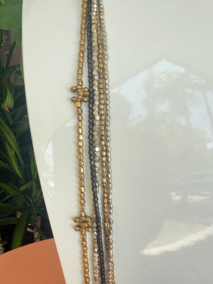 Close-up of a beaded necklace on a white surface, Cluster Silver, Metal. Dark Metal 17" long beaded necklace 