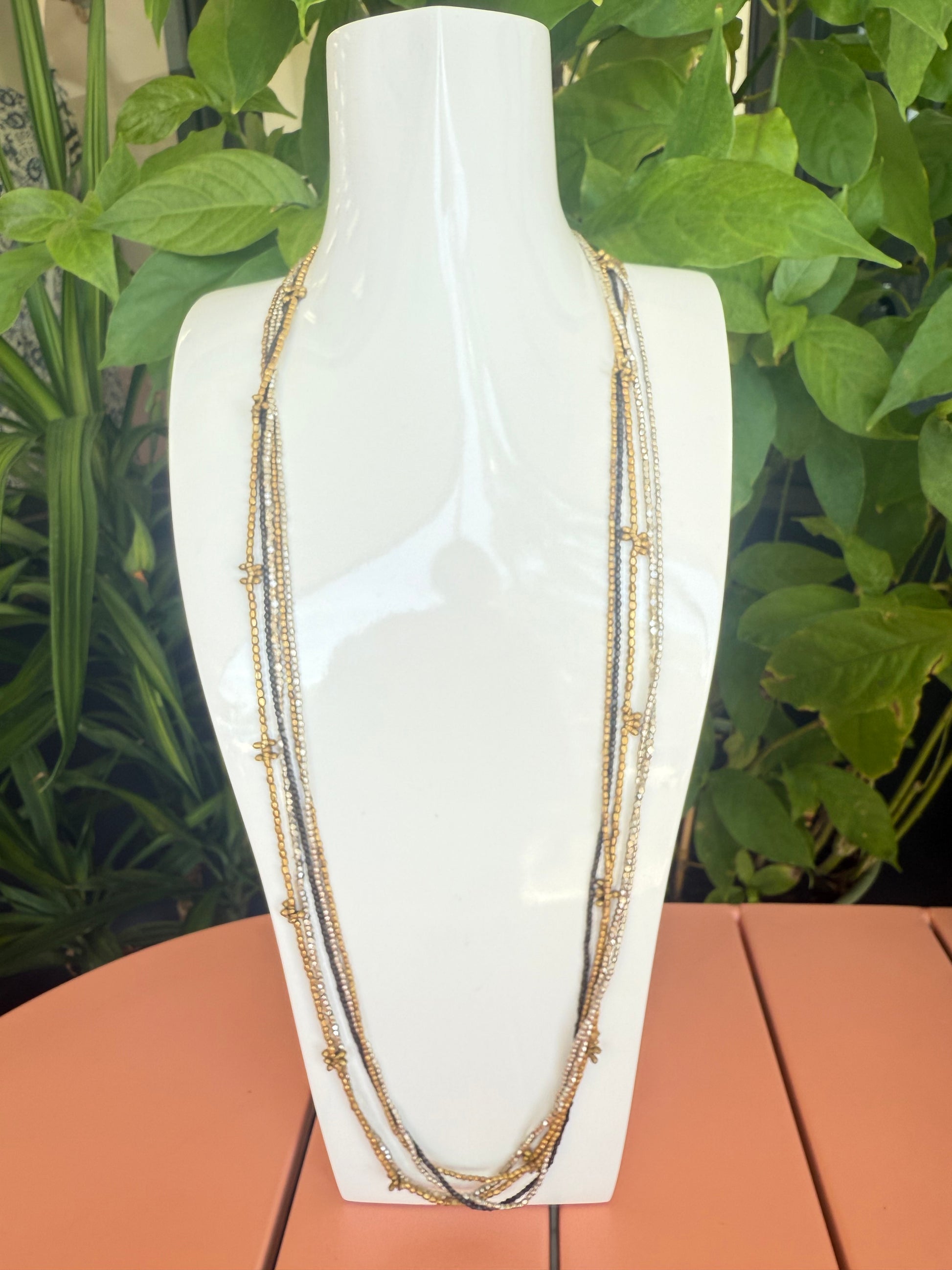 Decorative headband with gold accents on a white background. Cluster Silver, Metal. Dark Metal 17" long beaded necklace 