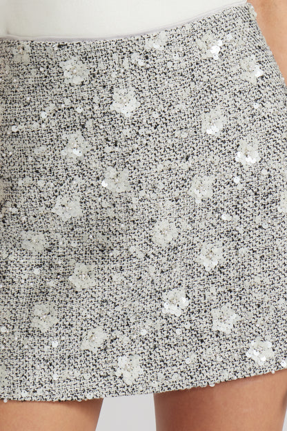 Close-up of a sequined skirt with a white background, a staple for curated boutique fashion and chic affordable style available at your Womens Boutique West Palm Beach, FL.
