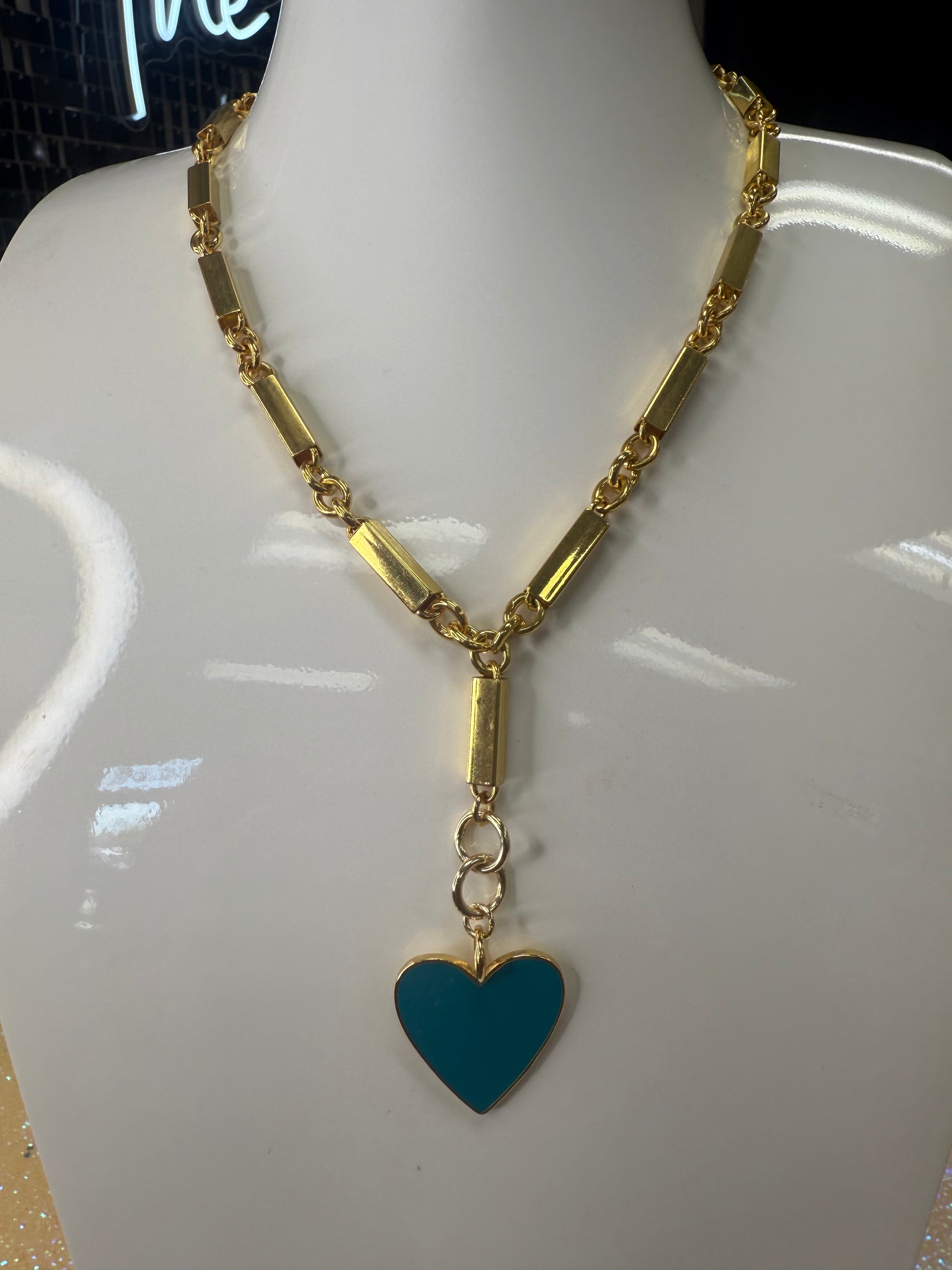 Add a splash of charm to your look with this playful Enamel Turquoise Heart pendant, hanging delicately from a gleaming gold chain. Its vibrant turquoise enamel brings a pop of color, while the heart shape adds a touch of whimsy and warmth. Perfect for brightening any outfit and sparking smiles wherever you go! A staple for curated boutique fashion and chic affordable style available at your Women's Boutique West Palm Beach, FL