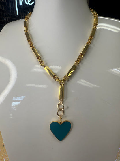 Add a splash of charm to your look with this playful Enamel Turquoise Heart pendant, hanging delicately from a gleaming gold chain. Its vibrant turquoise enamel brings a pop of color, while the heart shape adds a touch of whimsy and warmth. Perfect for brightening any outfit and sparking smiles wherever you go! A staple for curated boutique fashion and chic affordable style available at your Women's Boutique West Palm Beach, FL