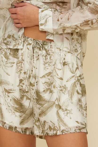 Person wearing a beige and brown floral patterned outfit with shorts and a top. Esme Printed  Elastic Waist Shorts, a staple for curated boutique fashion and chic affordable style available at your Womens Boutique West Palm Beach, FL.