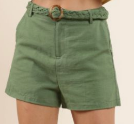 Green shorts with a belt on a beige background, Lindsey High-waisted Shorts w. Braided Belt, a staple for curated boutique fashion and chic affordable style available at your Womens Boutique West Palm Beach, FL.