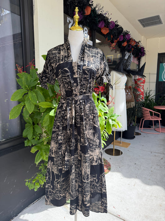 Mannequin wearing a black and white patterned dress with greenery in an indoor setting, Blue tracksuit on a mannequin with a decorative background. a staple for curated boutique fashion and chic affordable style available at your Womens Boutique West Palm Beach, FL.
