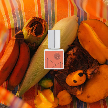 Fragrance bottle with pumpkins, corn, and bananas on a colorful striped background Kelly + Jones Mezcal Blanca perfume oil packaging on a white background. a staple for curated boutique fashion and chic affordable style available at your Womens Boutique West Palm Beach, FL.