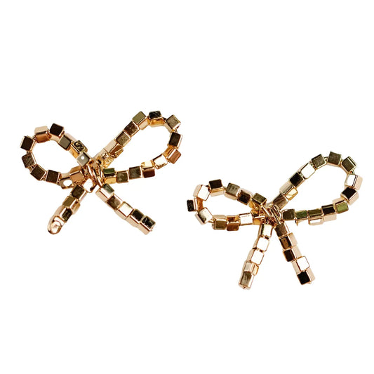 Gold bow-shaped earrings on a white background