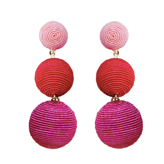 Pair of earrings with pink, red, and purple spherical designs on a white background