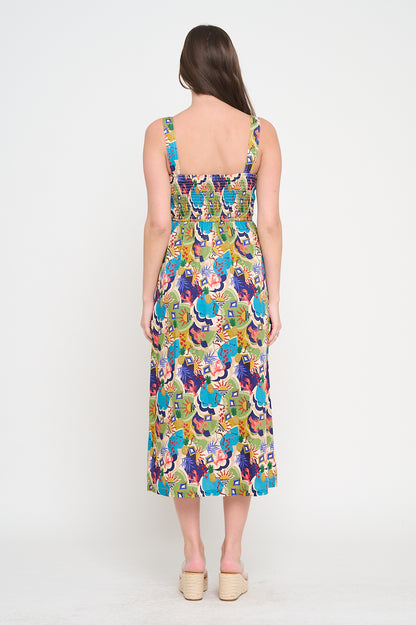 Woman wearing a colorful floral dress on a white background. Raquel Midi Printed Dress a staple for curated boutique fashion and chic affordable style available at your Womens Boutique West Palm Beach, FL.