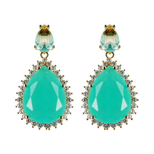 Turquoise teardrop earrings with gold accents on a white background